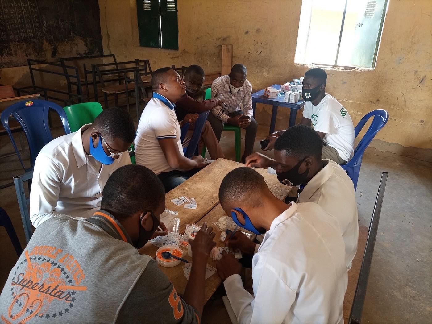 Outreach volunteers preparing medicines at a community medical outreach