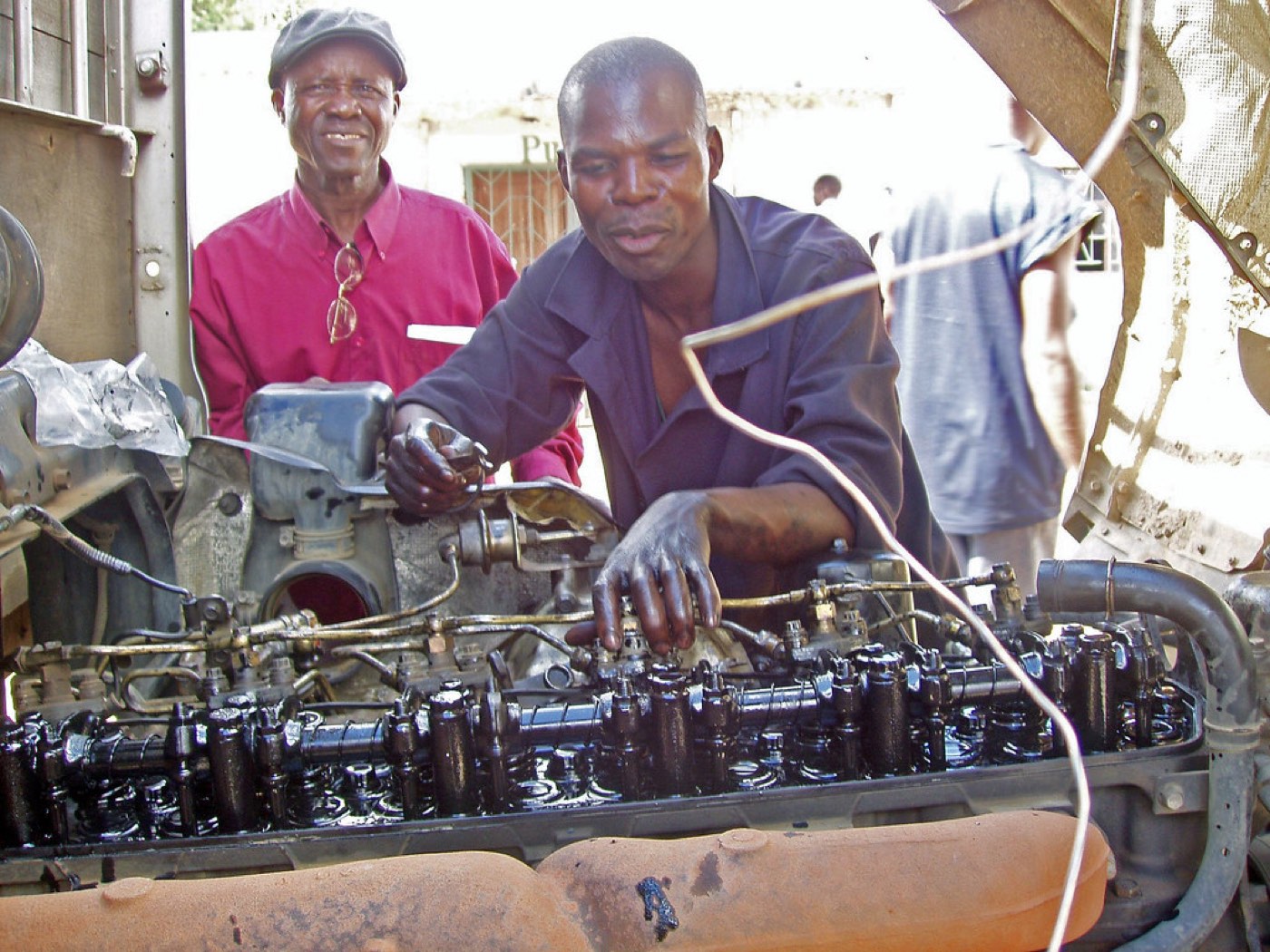 Trainees working on an engine at a vocational training centre